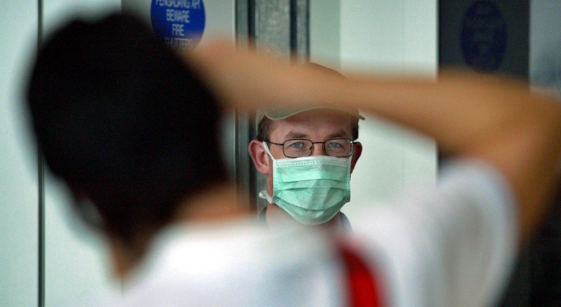  Mal&aacute;sia, Kuala Lumpur, 2003. Turista usa m&aacute;scara facial para se proteger da gripe provocada pelo SARS | Bazuki Muhammad - Reuters 