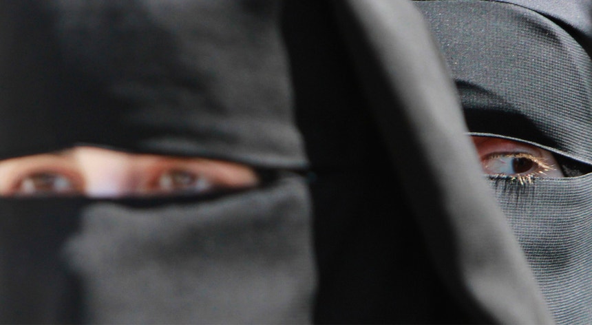 Os véus islâmicos, como o niqab, que cobre todo o rosto exceto os olhos, e a burca, que esconde rosto e corpo por completo, não foram mencionados como roupa específica a ser proibida pela legislação
