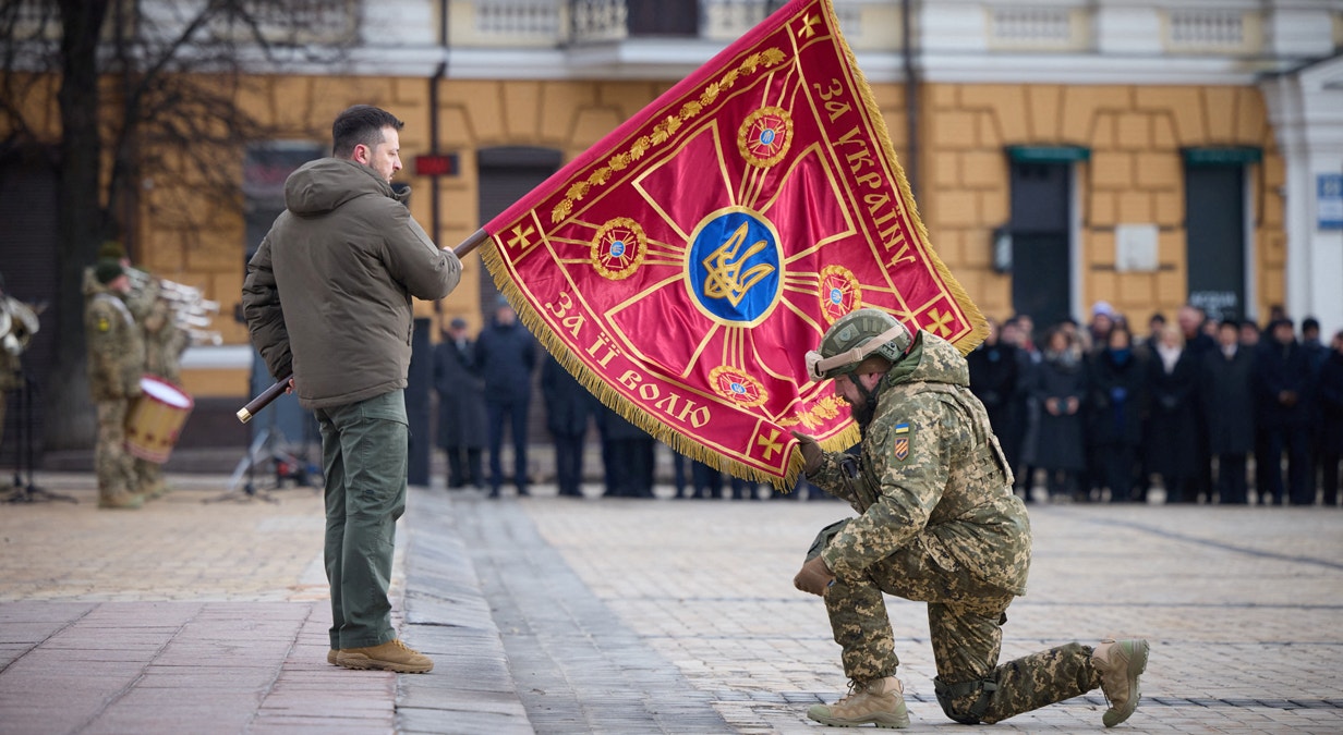  Kiev. O presidente da Ucr&acirc;nia, Volodymyr Zelensky, entrega uma bandeira a um militar | Gabinete de Imprensa presidencial via Reuters  