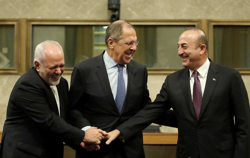 Os ministros dos Negócios estrangeiros do Irão, Rússia e Turquia, num encontro sobre a Síria em Genebra, a 18 de dezembro de 2018 Foto: Reuters 