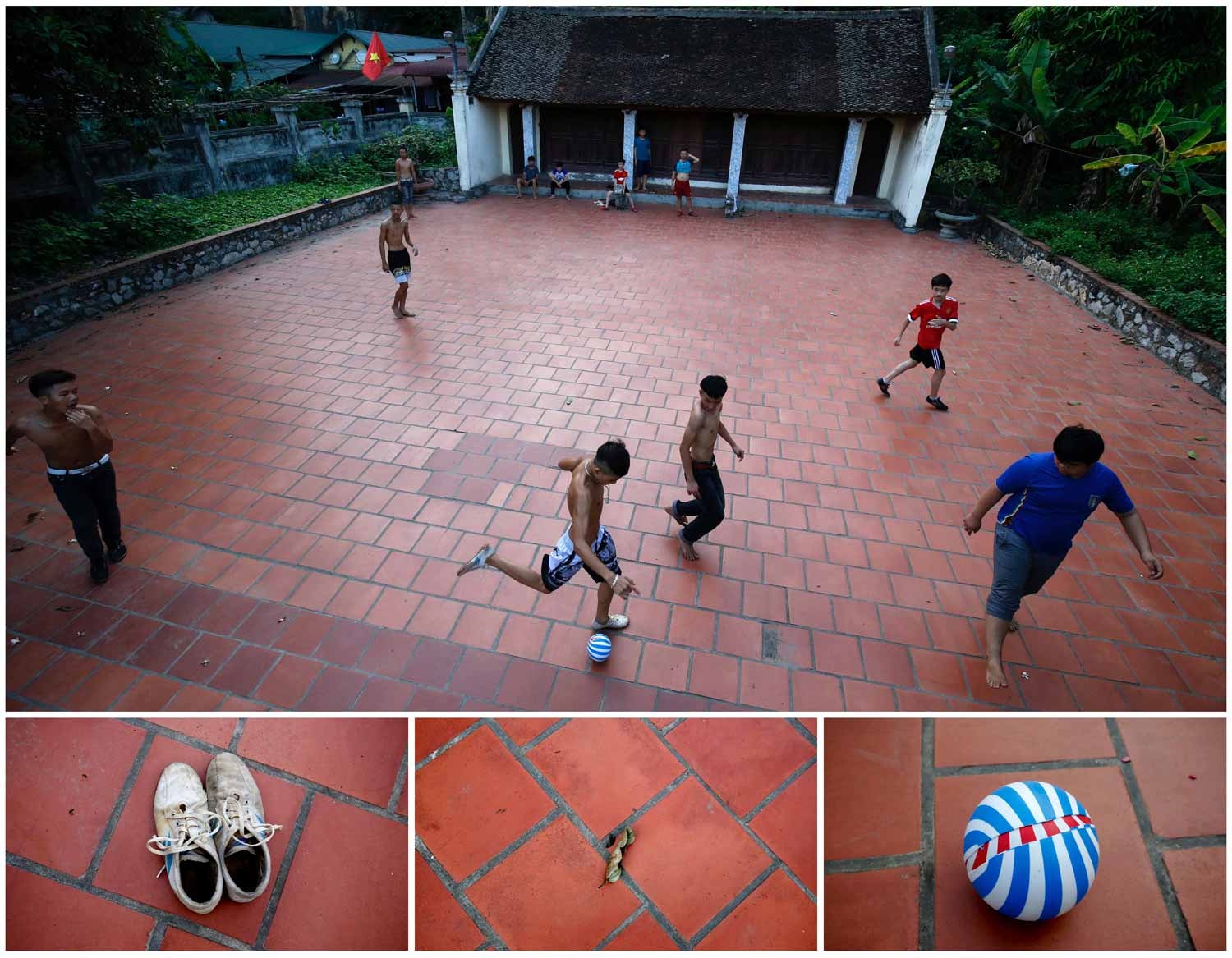  Na cidade de Han&oacute;i, capital do Vietname, um grupo de crian&ccedil;as joga uma partida de futebol em frente a um templo na aldeia de Hoang Xa. Foto: Nguyen Huy Kham - Reuters    