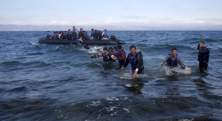 Migrantes chegam de barco à ilha grega de Lesbos; o mau tempo no Mediterrâneo fez diminuir as chegadas diárias, de 5.500 para 1.500 em poucos dias
