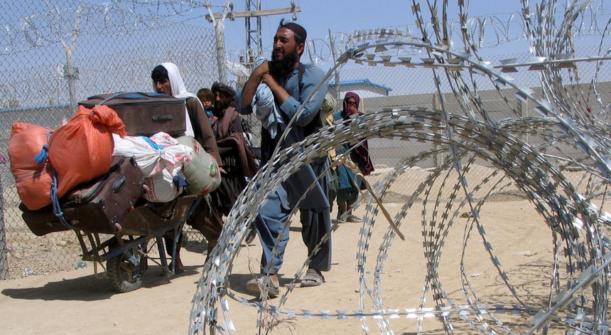 Uma família afegã atravessa a fronteira "da amizade" entre o Afeganistão e o Paquistão
