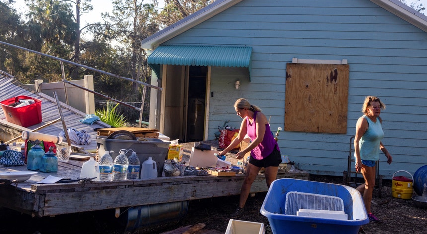 Two women trying to recover what is left of their home after Hurricane Helene