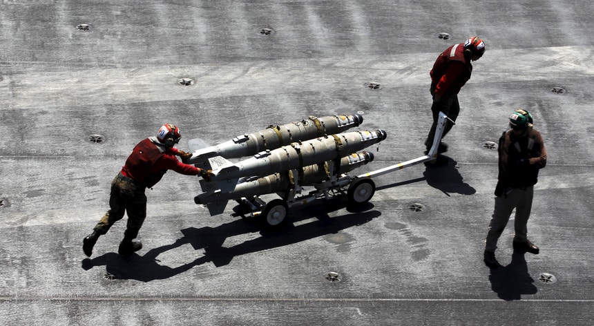 Militares norte-americanos deslocam mísseis sobre o convés do porta-aviões USS Theodore Roosevelt, no Golfo (fotografia de junho de 2015)
