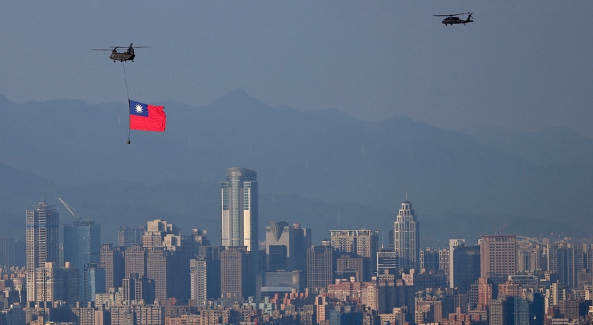 Um helicóptero militar CH-47 transporta uma bandeira de Taiwan sobre Taipé durante os ensaios para as celebrações do Dia Nacional - celebrado a 10 de outubro
